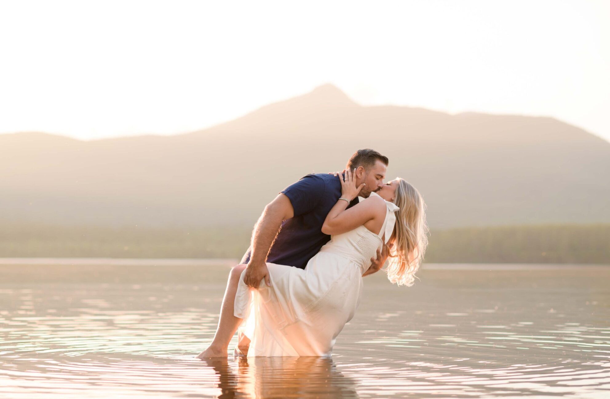 Engaged couple kisses in Front of mountains in New England