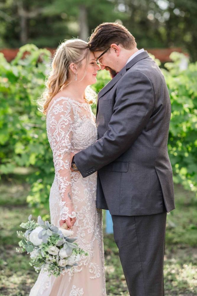 Newlyweds Holding Each other in Vineyard